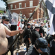 When your hatred is literally burning you up from the inside—white supremacist protestor brandishes flag in Charlottesville, VA. (Photo: Chip Somodevilla/Getty Images)